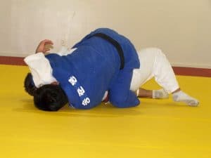 Head Judo Coach Demonstrating A Pinning Technique