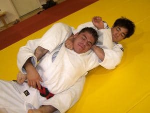 Two Male Judokas Demonstrating A Choke