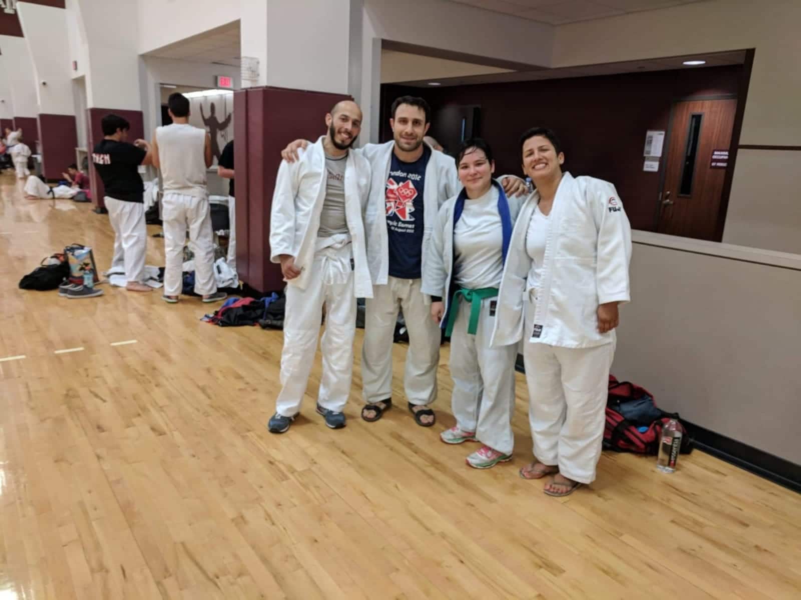 judo athletes pose for a picture after competition