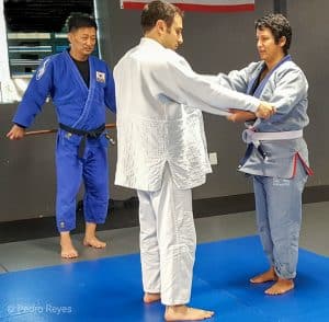 female judoka athlete being coached one on one