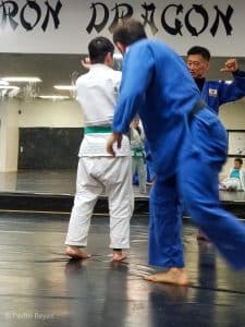 female athlete judoka recieving correction on judo technique
